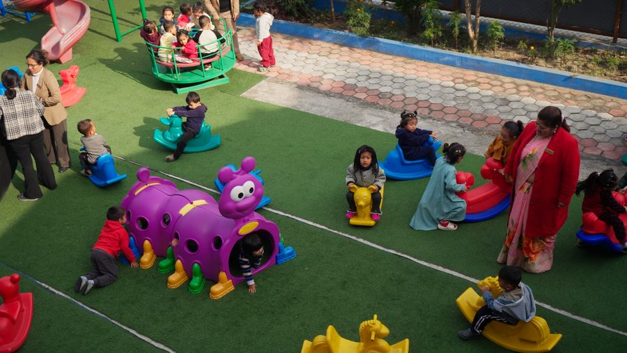 Children playing on the artificial-turf playground at Kovida Pre School
